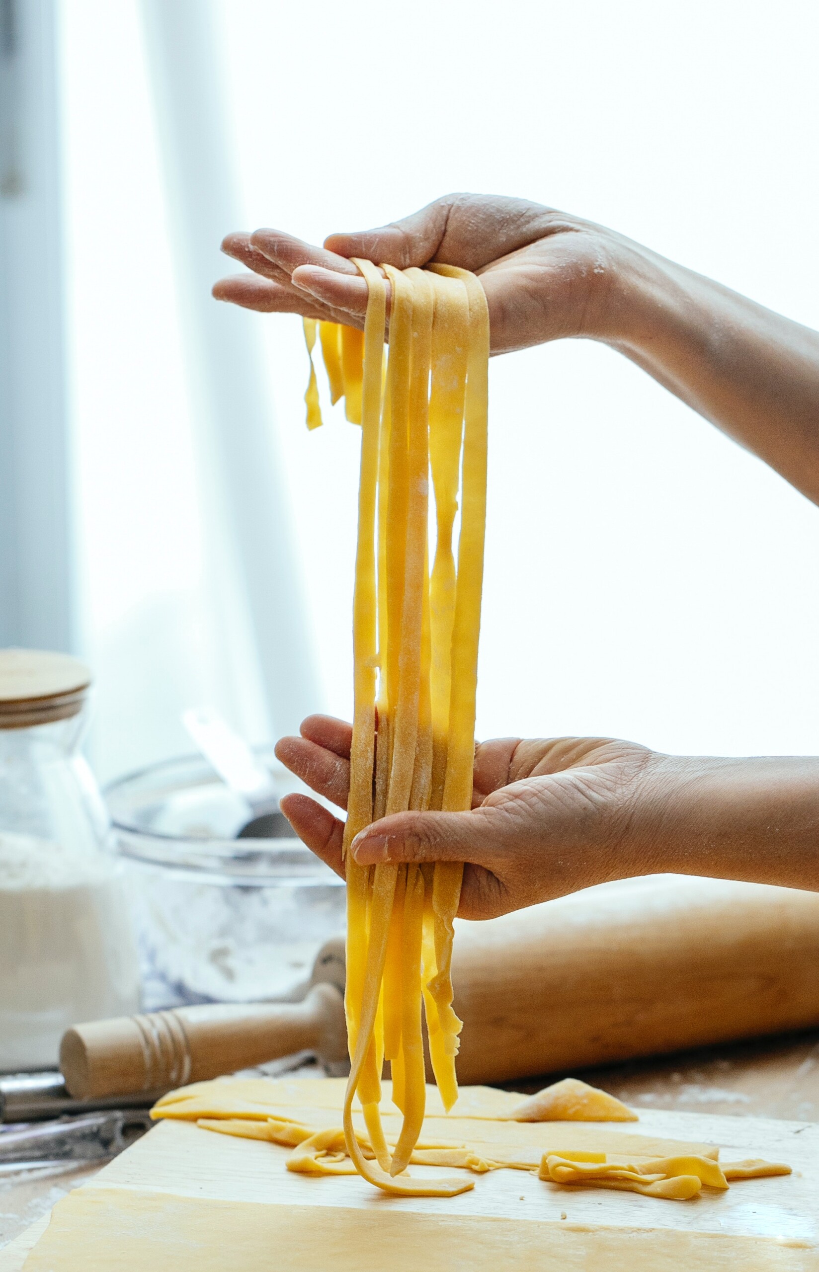 Hands preparing fresh pasta during a cooking experience
